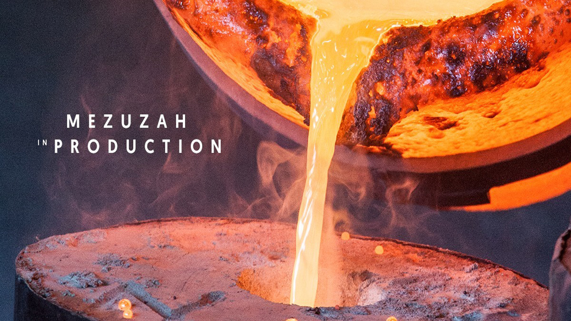 Molten metal is poured into a mold at Rynek Podgórski 2 in Krakow, creating a MEZUZAH. "Mezuzah in Production" appears on the left as steam and sparks rise from the intense heat of this Judaica process.