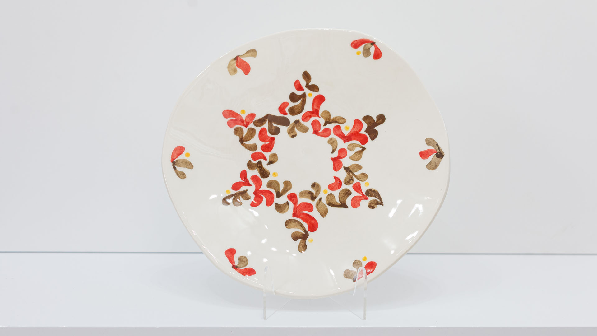 Star of David Jewish plate. The ceramic plate was treated as a painting. The Star of David plate was hand-painted by Helena Czernek co-designer MI POLIN, who, together with Aleksander Prugar, developed the unique painting patterns. The plates painting are inspired by Polish graphic design of the 1960s and 1970s. This refers to the pottery factories of Włocławek and Tułowice. Made at MI POLIN and entirely manufactured in Poland.