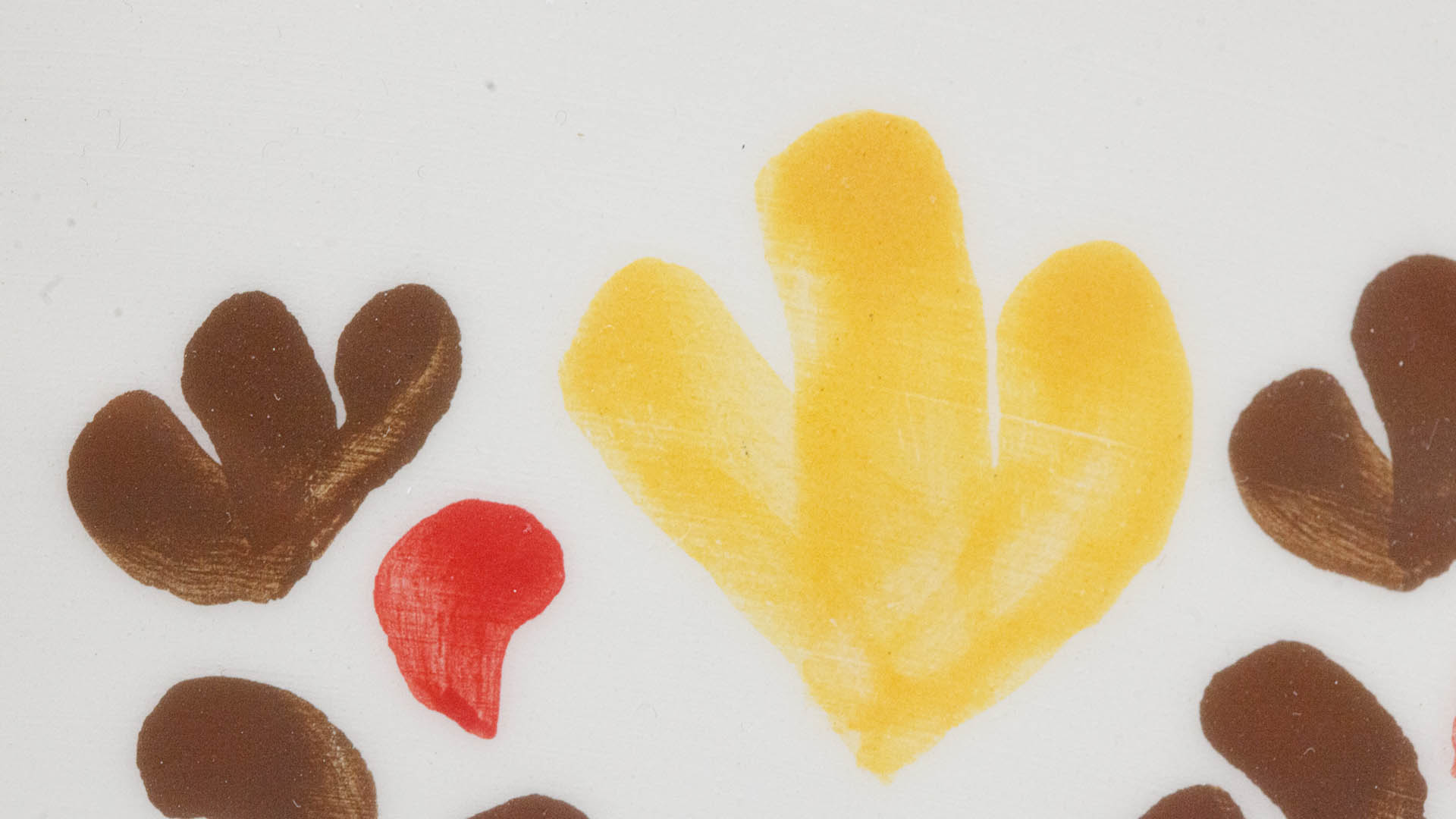 A close-up of a hand-painted plate with a Menorah Jewish plate. Hand-painted Jewish Judaica. Brushstrokes and ceramic glaze are visible. Highly precise craftsmanship.