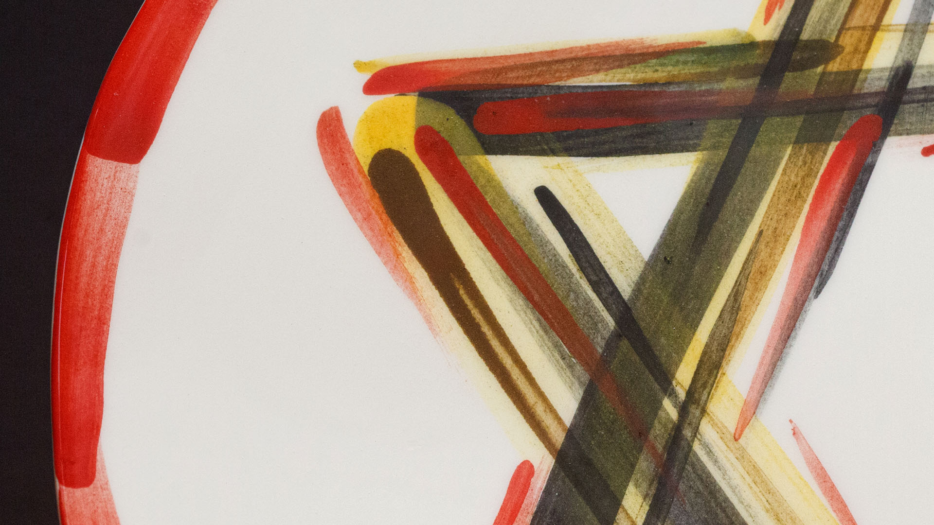 A close-up of a hand-painted plate with a Star of David plate. Hand-painted Jewish Judaica. Brushstrokes and ceramic glaze are visible. Highly precise craftsmanship.