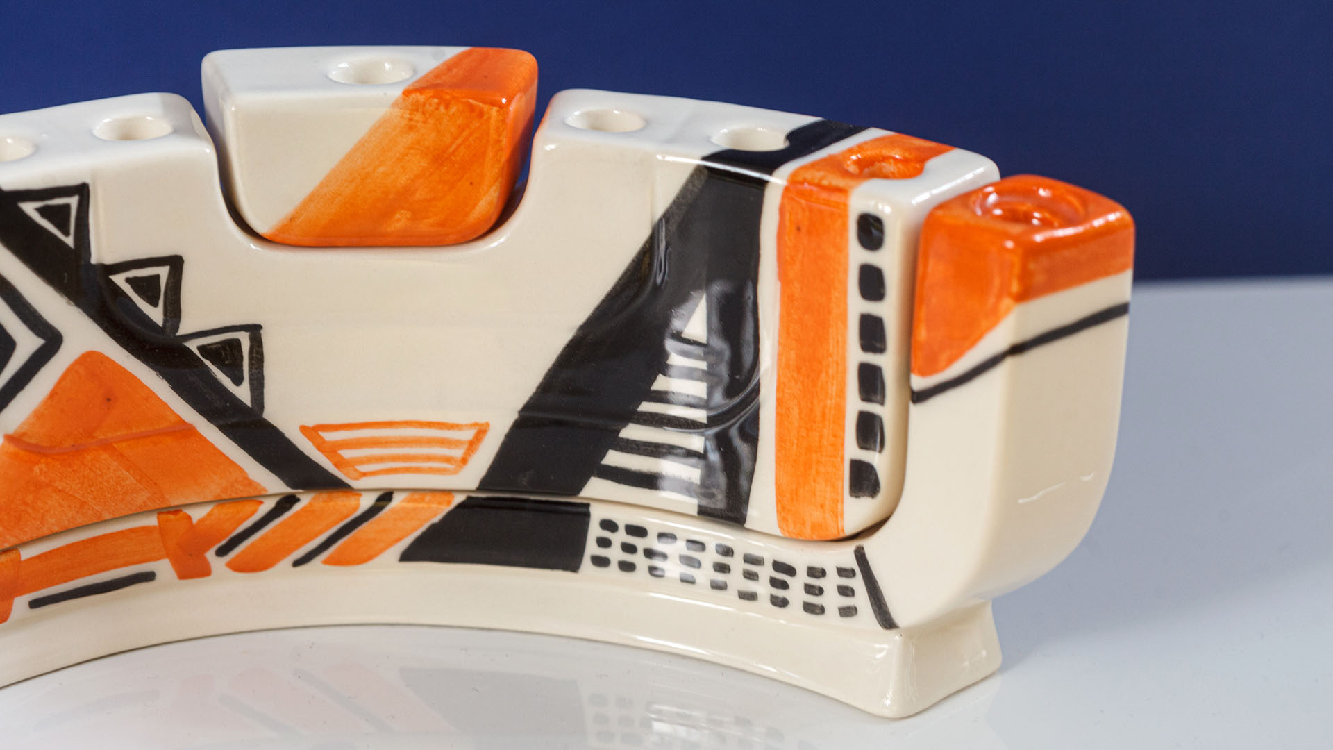 Hand painted Judaica. Menorah designed by MI POLIN which consists of decorative elements in the form of lines in dark orange, brown and black stripes. The candlestick painting are inspired by Polish graphic design of the 1960s and 1970s. Hand-painted by Helena Czernek MI POLIN, together with Aleksander Prugar. A perfect gift for a Bar Mitzvah, Bat Mitzvah, birthday, or as a decoration in a modern Jewish home.