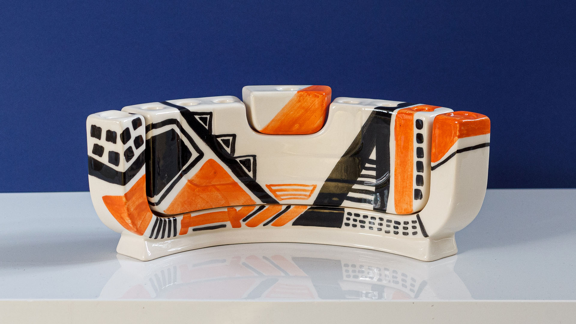 Hand painted Judaica. Menorah designed by MI POLIN which consists of decorative elements in the form of lines in dark orange, brown and black stripes. The candlestick painting are inspired by Polish graphic design of the 1960s and 1970s. Hand-painted by Helena Czernek MI POLIN, together with Aleksander Prugar. A perfect gift for a Bar Mitzvah, Bat Mitzvah, birthday, or as a decoration in a modern Jewish home.