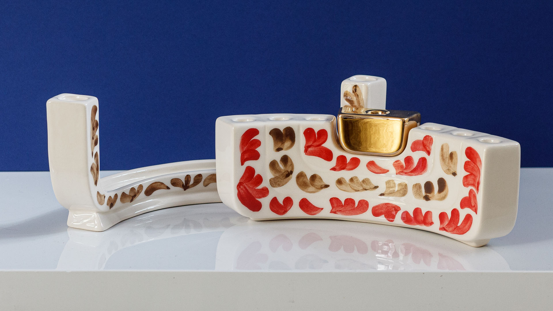 Hand painted Judaica. Menorah designed by MI POLIN which consists of decorative elements in the form of lines in dark orange, brown and black stripes. The candlestick painting are inspired by Polish graphic design of the 1960s and 1970s. Hand-painted by Helena Czernek MI POLIN, together with Aleksander Prugar. A perfect gift for a Bar Mitzvah, Bat Mitzvah, birthday, or as a decoration in a modern Jewish home.