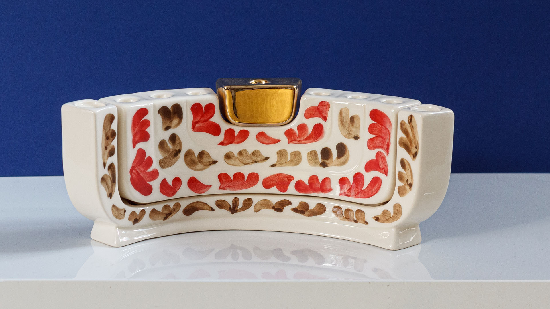 Hand painted Judaica. Menorah designed by MI POLIN which consists of decorative elements in the form of lines in dark orange, brown and black stripes. The candlestick painting are inspired by Polish graphic design of the 1960s and 1970s. Hand-painted by Helena Czernek MI POLIN, together with Aleksander Prugar. A perfect gift for a Bar Mitzvah, Bat Mitzvah, birthday, or as a decoration in a modern Jewish home.