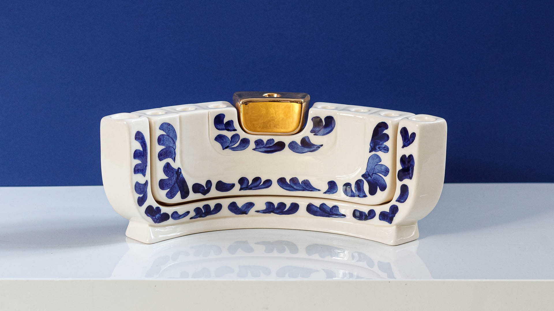 Jewish menorah called the MENOKIAH. Designed by MI POLIN, this stylish menorah combines two Jewish candlesticks: the menorah and a two-branched Shabbat candlestick. Together, these elements form a Hanukkah menorah. This is our interpretation of Jewish tradition! For this reason, Menokiah can be used every week on Shabbat and once a year on Hanukkah