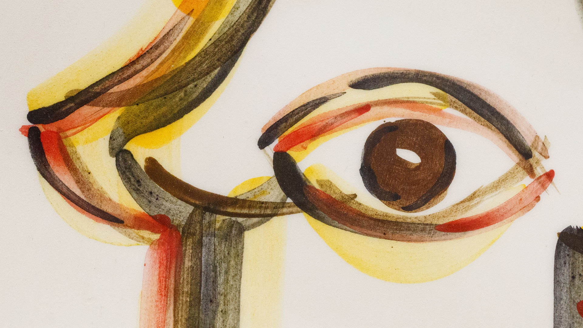 A close-up of a hand-painted plate with a Hamsa plate. Hand-painted Jewish Judaica. Brushstrokes and ceramic glaze are visible. Highly precise craftsmanship.