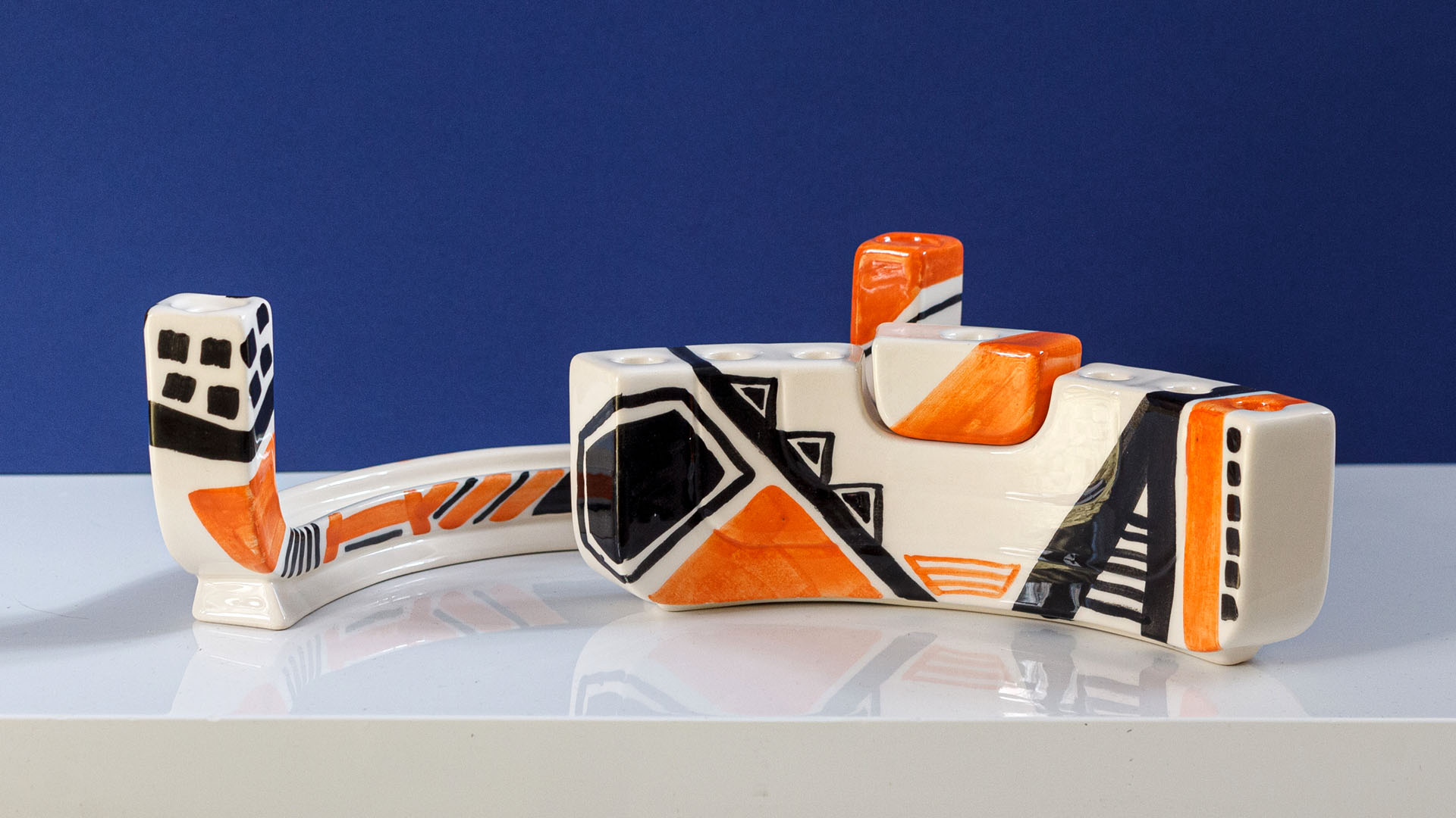 Hand painted Judaica. Menorah designed by MI POLIN which consists of decorative elements in the form of lines in dark orange, brown and black stripes. The candlestick painting are inspired by Polish graphic design of the 1960s and 1970s. Hand-painted by Helena Czernek MI POLIN, together with Aleksander Prugar. A perfect gift for a Bar Mitzvah, Bat Mitzvah, birthday, or as a decoration in a modern Jewish home.