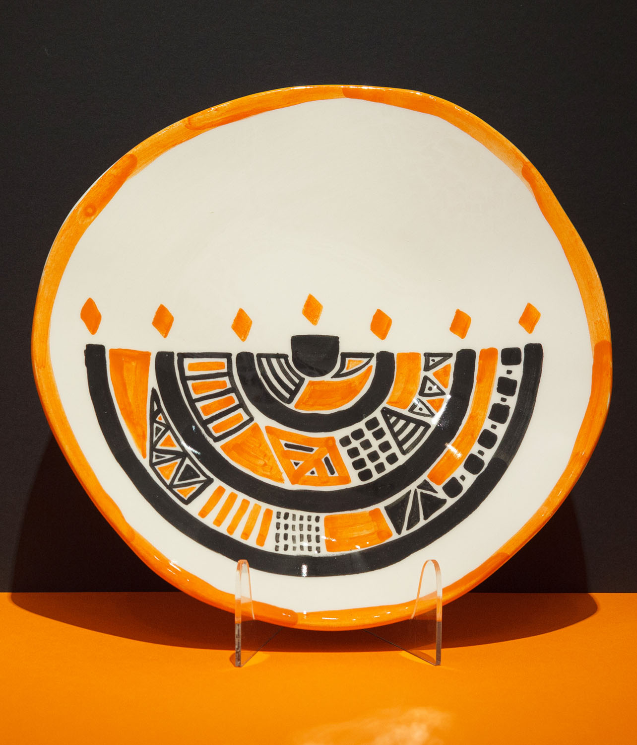 A Jewish Seder plate that became a painting. The brushwork and paintwork are visible. The plate was then fired with a colorless glaze. The menorah symbol is visible.