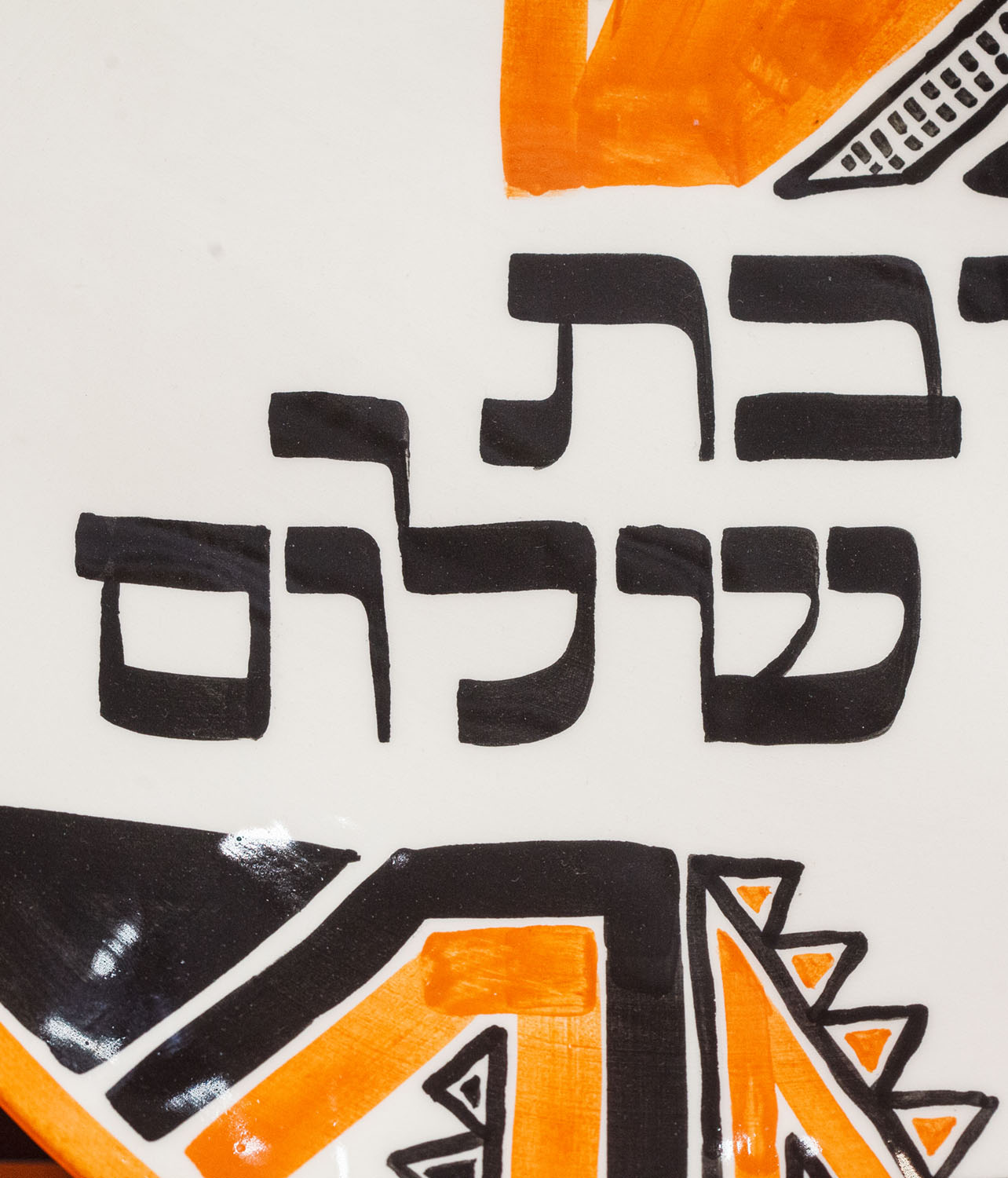 The Hebrew inscription Shabbat Shalom visible on a decorative Jewish plate,