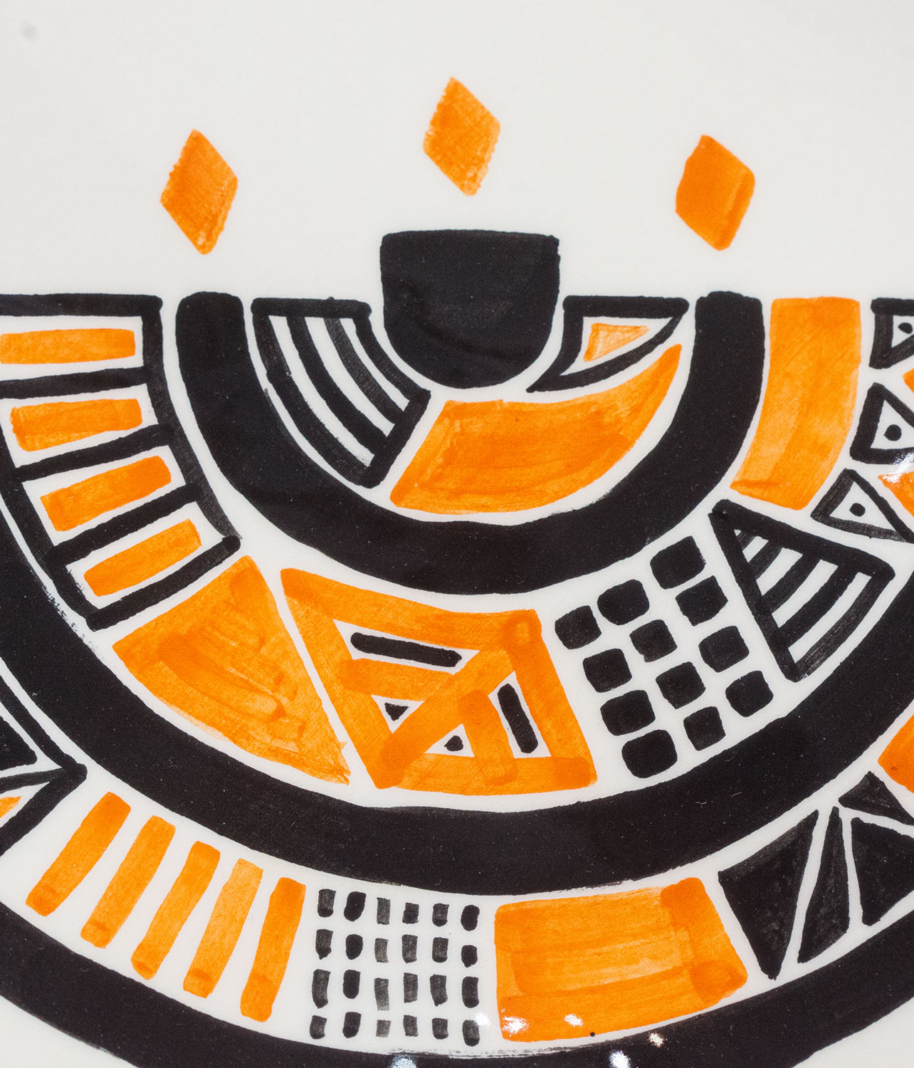 A Jewish Seder plate that became a painting. The brushwork and paintwork are visible. The plate was then fired with a colorless glaze. The menorah symbol is visible.