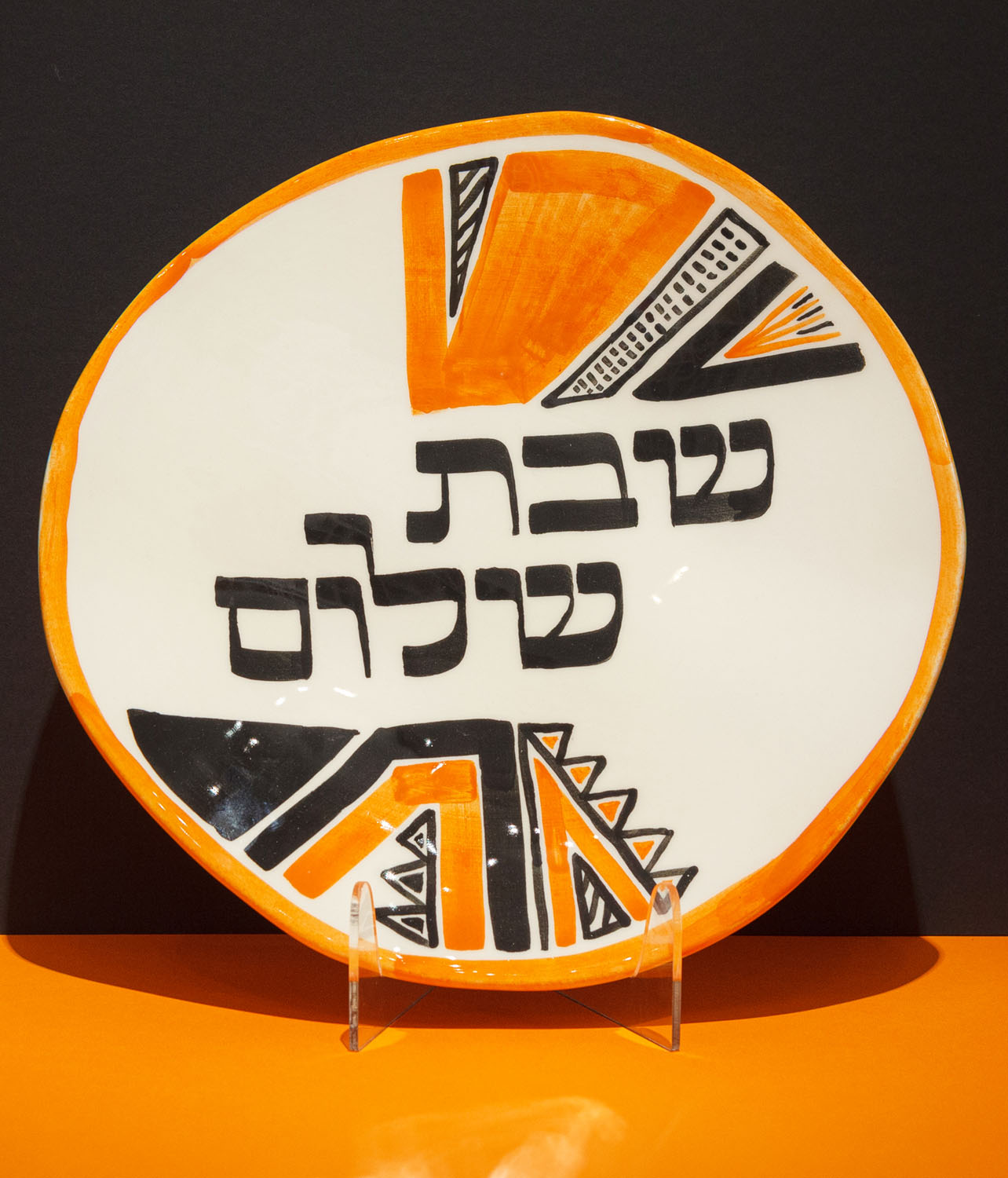 The Hebrew inscription Shabbat Shalom visible on a decorative Jewish plate,