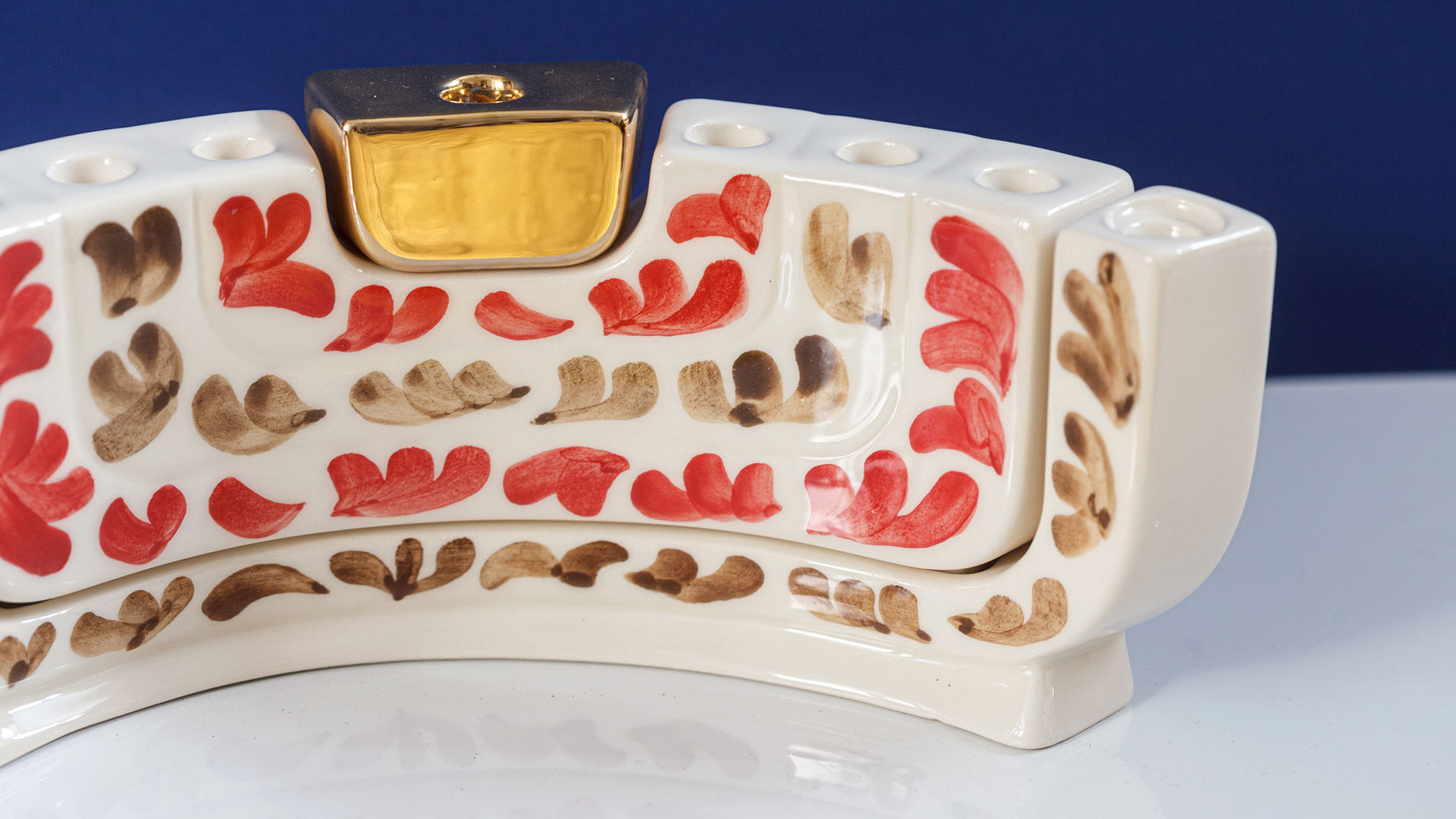 The Menokiah is a custom menorah designed by MI POLIN. It combines three traditional Jewish candlesticks: a two-arm Shabbat candlestick, a Hanukkah, and a menorah.